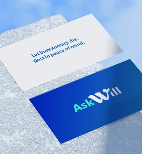Business card with AskWill logo and legal quote on a textured surface.
